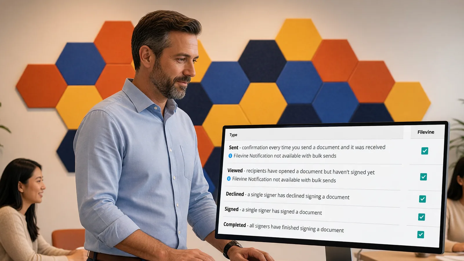 A Vinesign admin reviews the Filevine notification settings while colleagues talk nearby